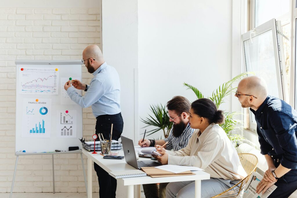 A diverse group of professionals discussing financial data in a modern office setting.